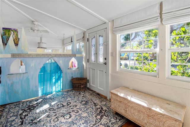 unfurnished sunroom featuring lofted ceiling and a ceiling fan