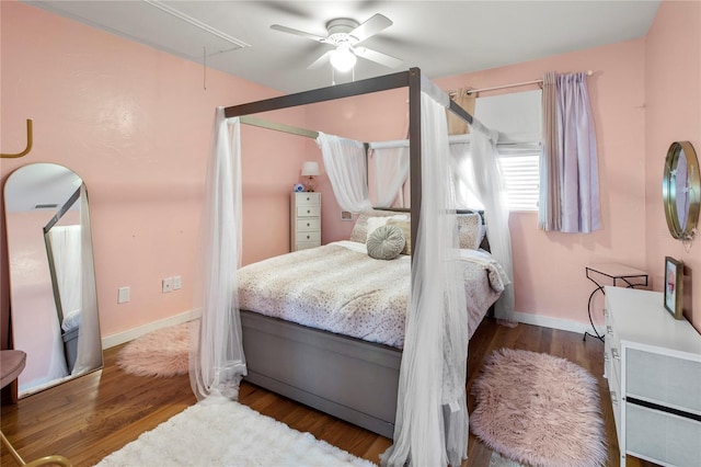 bedroom with attic access, baseboards, ceiling fan, and wood finished floors