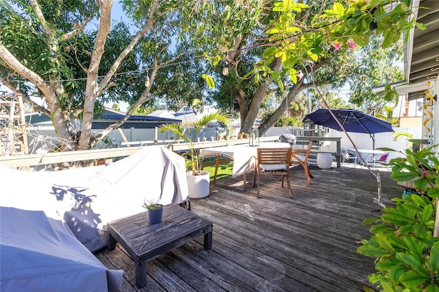 wooden deck with fence and outdoor dining area