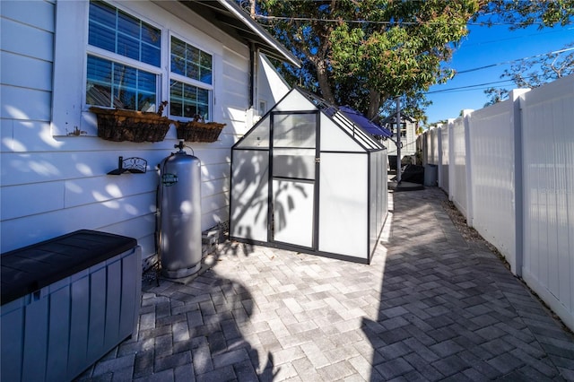 view of patio featuring an outbuilding and a fenced backyard