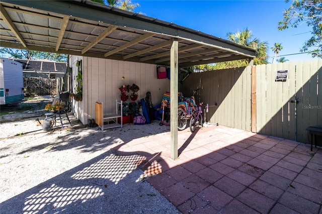 view of patio / terrace featuring a carport and fence