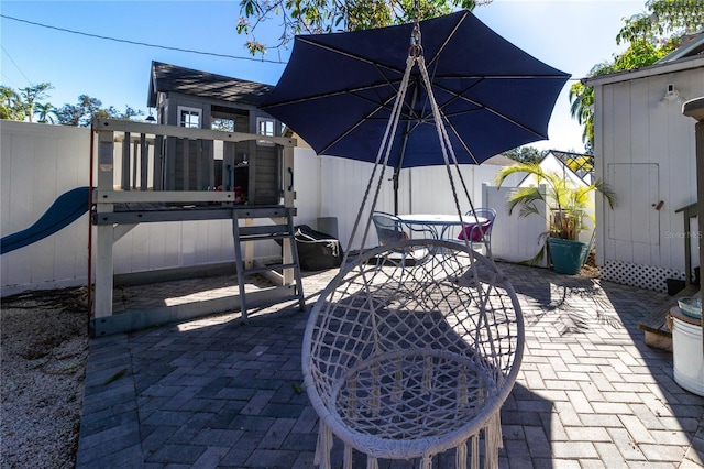 view of patio with outdoor dining space and a fenced backyard