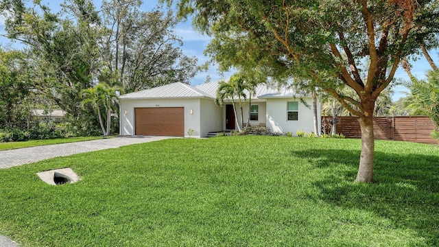 single story home featuring fence, a front yard, stucco siding, a garage, and driveway