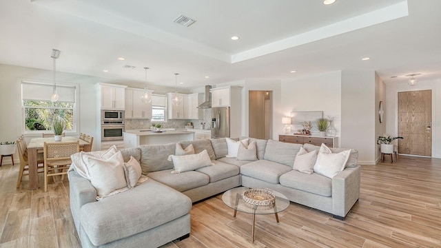 living room featuring visible vents, recessed lighting, and light wood-type flooring