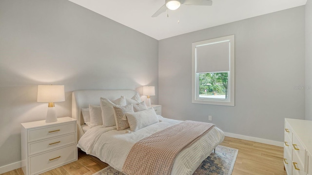 bedroom featuring baseboards, a ceiling fan, and light wood finished floors