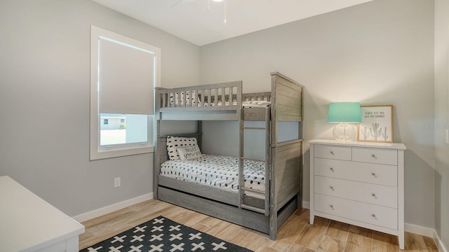 bedroom with light wood-type flooring and baseboards