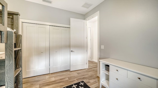 bedroom featuring visible vents, a closet, and light wood-type flooring