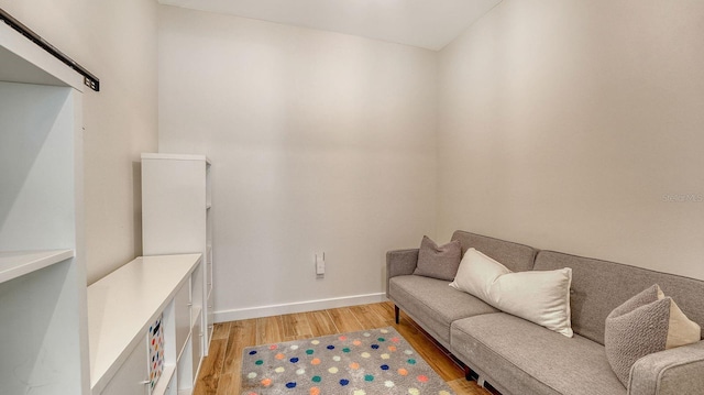 sitting room with light wood-style flooring and baseboards