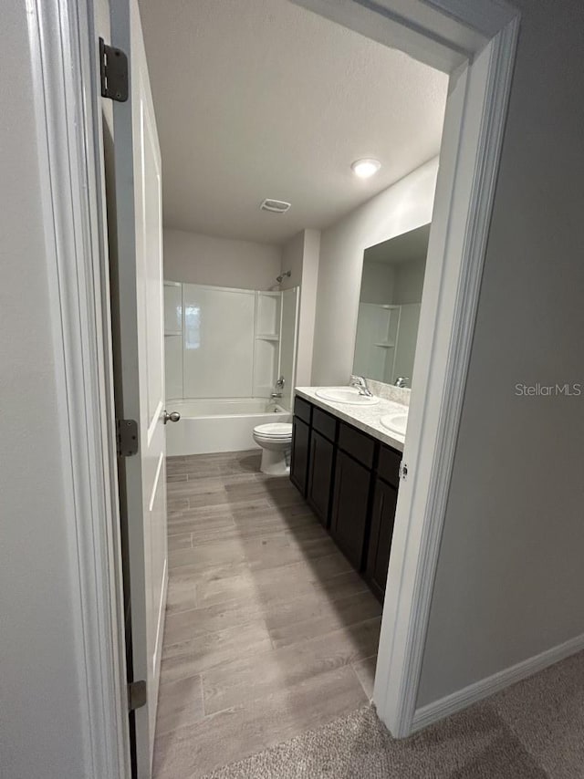 13633 NW 14th Pl, Newberry, FL 32669 - full bath featuring double vanity, toilet, tub / shower combination, a sink, and wood finished floors