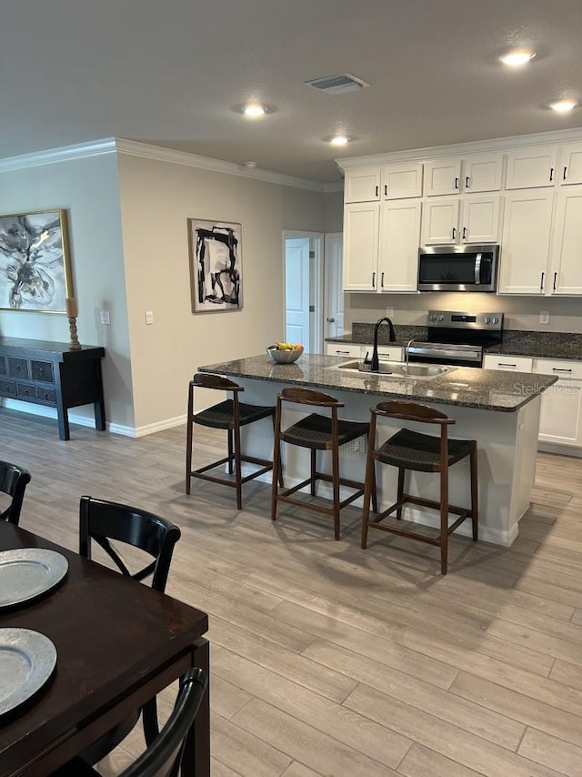 13633 NW 14th Pl, Newberry, FL 32669 - kitchen featuring light wood finished floors, crown molding, stainless steel appliances, and a sink