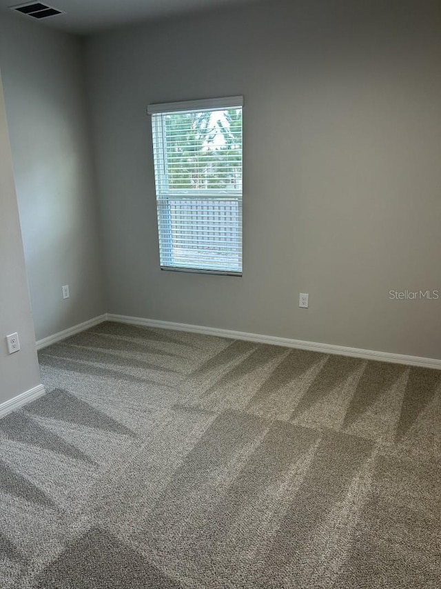 13633 NW 14th Pl, Newberry, FL 32669 - empty room featuring carpet floors, visible vents, and baseboards