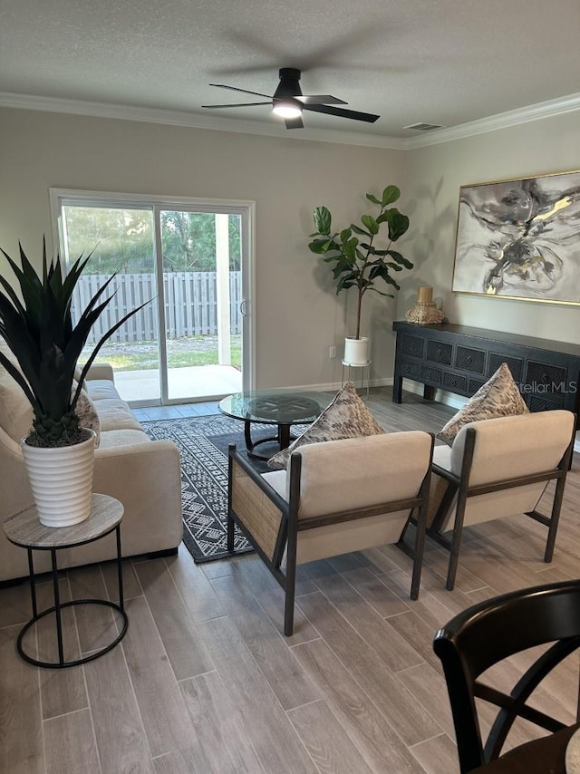 13633 NW 14th Pl, Newberry, FL 32669 - living area featuring visible vents, crown molding, a textured ceiling, and wood finished floors