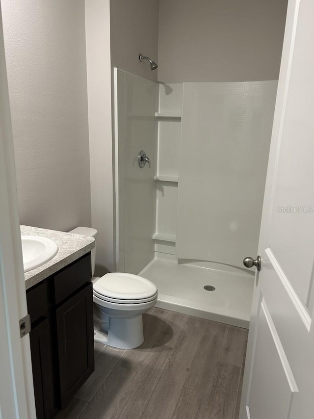 13633 NW 14th Pl, Newberry, FL 32669 - full bath with toilet, a stall shower, wood finished floors, and vanity