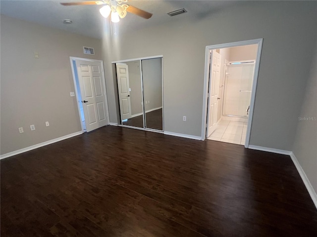 unfurnished bedroom featuring baseboards, visible vents, and wood finished floors