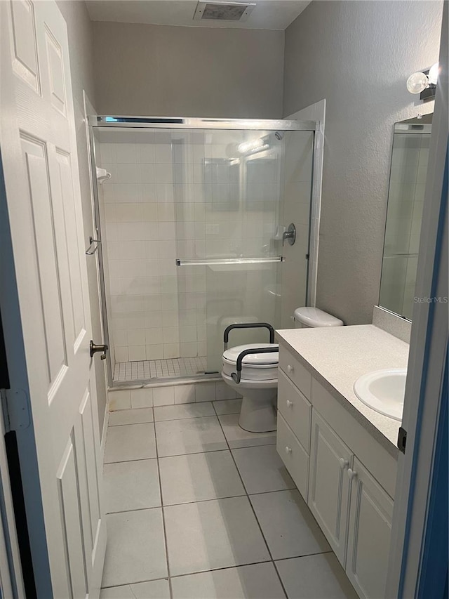 bathroom featuring visible vents, a stall shower, vanity, and toilet