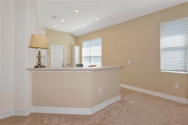 kitchen featuring recessed lighting, visible vents, light colored carpet, a peninsula, and baseboards