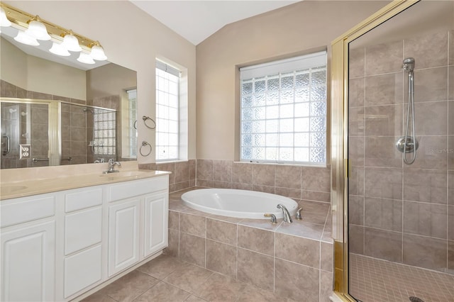 full bath featuring lofted ceiling, a shower stall, a sink, and tile patterned floors