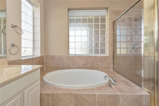 full bath with a shower stall, a bath, and vanity