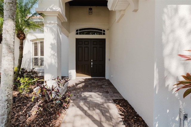 entrance to property with stucco siding