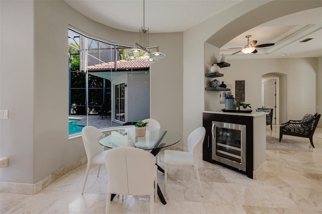 dining space featuring arched walkways, visible vents, marble finish floor, and baseboards