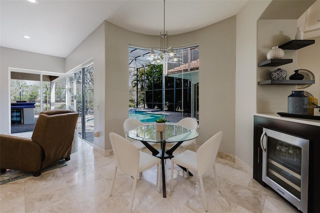 dining area with recessed lighting, baseboards, wine cooler, and marble finish floor