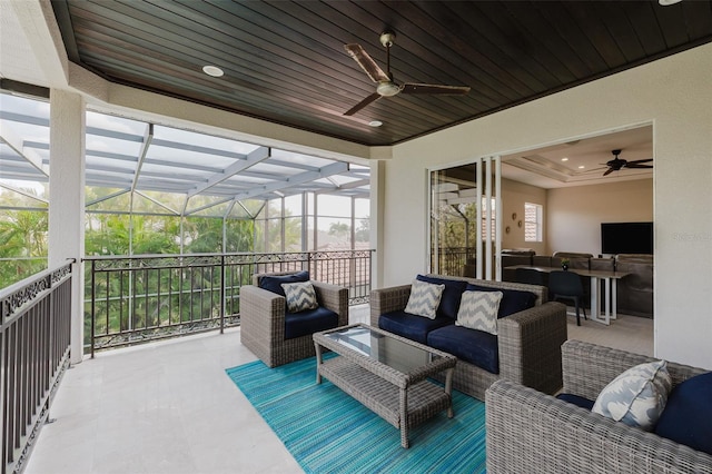 view of patio / terrace featuring a ceiling fan, a lanai, and outdoor lounge area