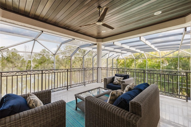 exterior space with glass enclosure, ceiling fan, and outdoor lounge area