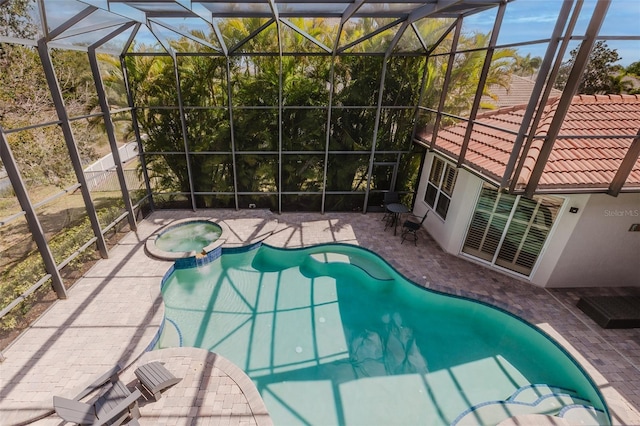 view of pool featuring a patio, a lanai, and a pool with connected hot tub