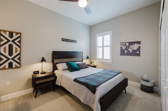 carpeted bedroom featuring baseboards and ceiling fan