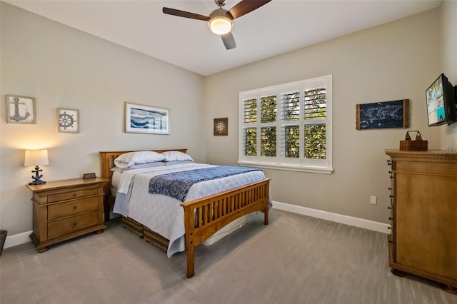 bedroom featuring a ceiling fan, light colored carpet, and baseboards