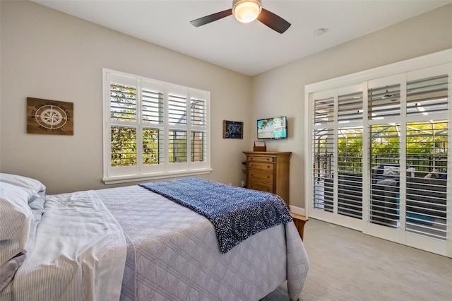 bedroom with access to exterior, multiple windows, and ceiling fan