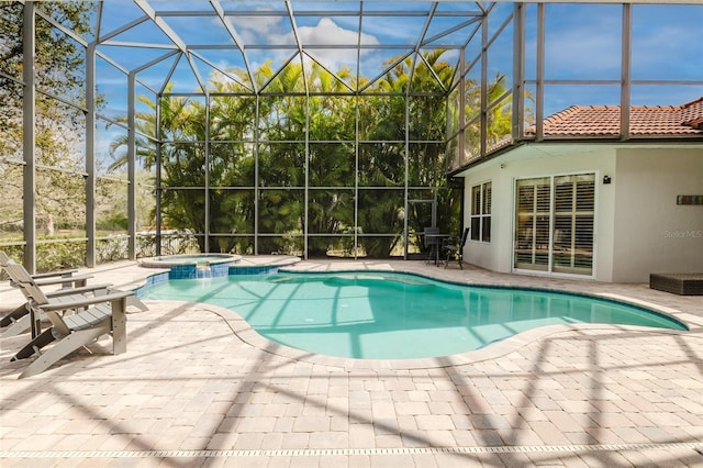 view of pool with a lanai, a patio area, and a pool with connected hot tub