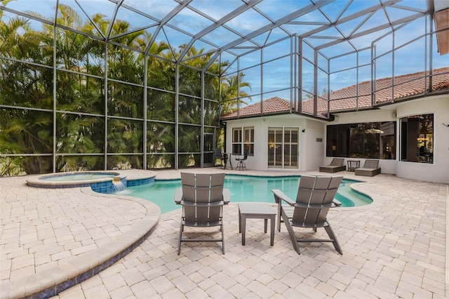 view of pool featuring a patio, a lanai, and a pool with connected hot tub