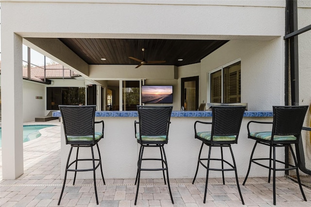 view of patio / terrace with outdoor dry bar and ceiling fan