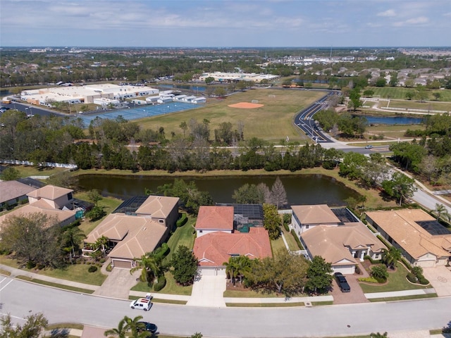 drone / aerial view featuring a residential view and a water view