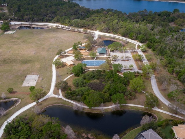 drone / aerial view featuring a view of trees and a water view