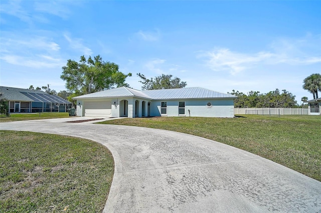 ranch-style house featuring stucco siding, driveway, fence, a front yard, and metal roof