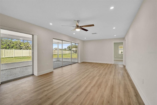 empty room featuring visible vents, baseboards, light wood-style flooring, recessed lighting, and ceiling fan