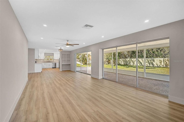 unfurnished living room featuring baseboards, recessed lighting, visible vents, and light wood-type flooring