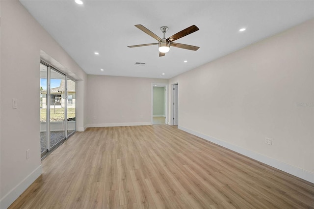 empty room featuring light wood finished floors, recessed lighting, and baseboards