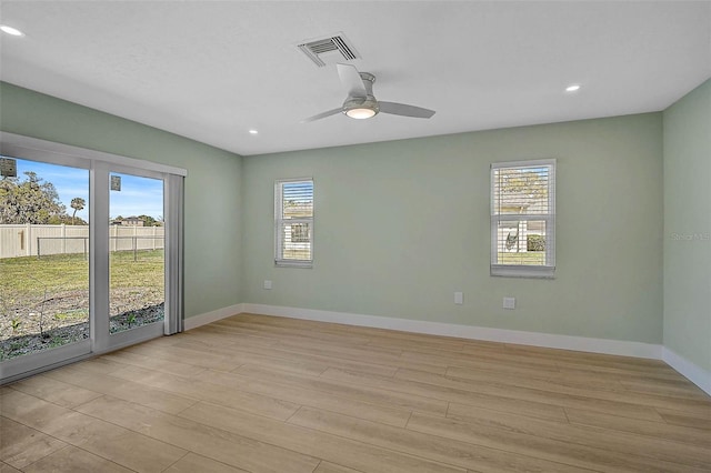 unfurnished room featuring light wood-type flooring, visible vents, a ceiling fan, recessed lighting, and baseboards