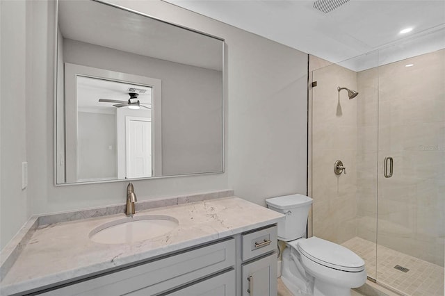 bathroom with visible vents, a stall shower, toilet, and vanity