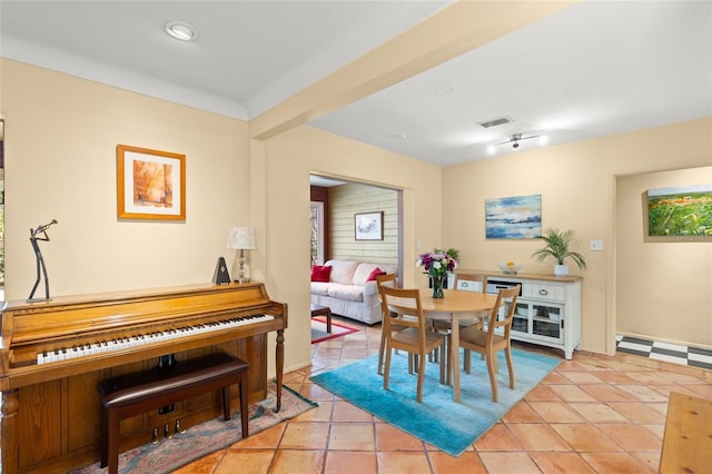 tiled dining space featuring visible vents