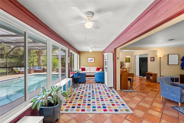 sunroom / solarium with a ceiling fan