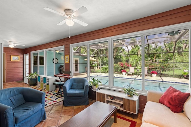 sunroom featuring ceiling fan