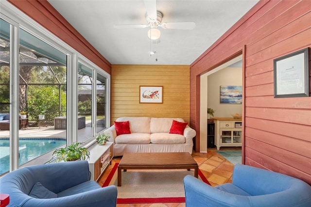 sunroom featuring a ceiling fan