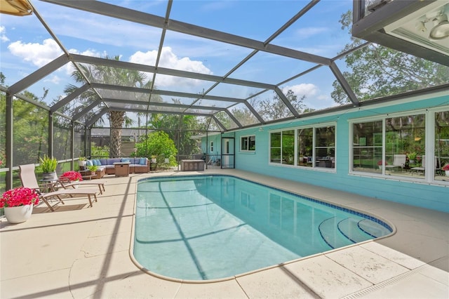 pool featuring a lanai, outdoor lounge area, and a patio