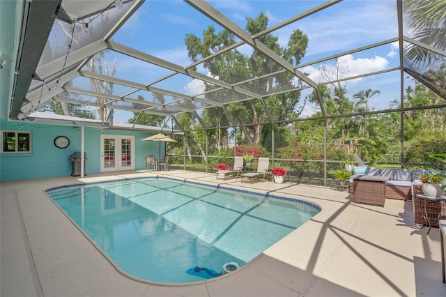 pool with french doors, glass enclosure, a patio, and grilling area