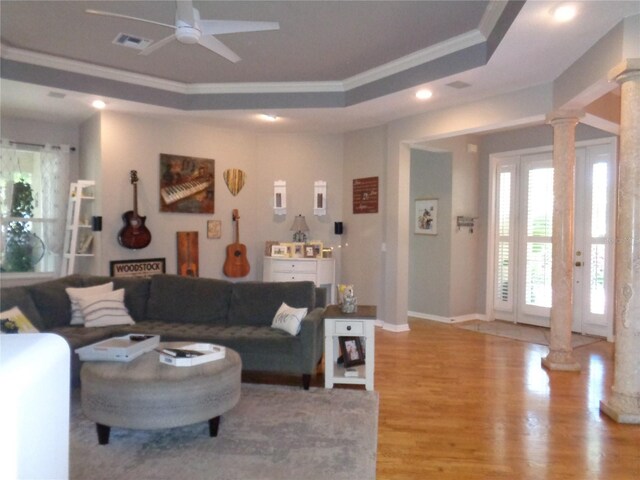 1354 Tearose Pl, Sarasota, FL 34239 - living area with visible vents, light wood finished floors, ornate columns, ornamental molding, and a raised ceiling