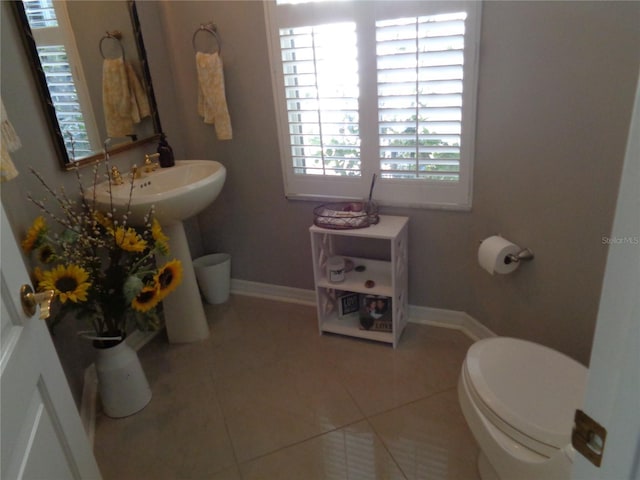 1354 Tearose Pl, Sarasota, FL 34239 - bathroom with tile patterned floors, toilet, baseboards, and a sink